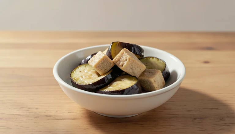 AI illustration of Illustration of cooked eggplant and tofu in a white bowl.